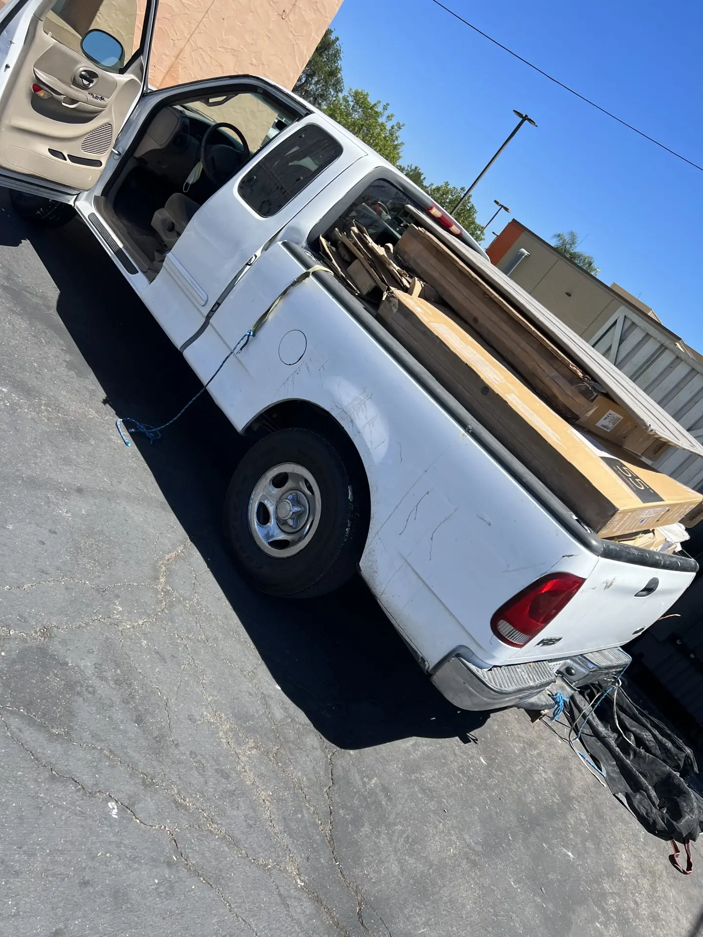 a white truck with cardboard in the back